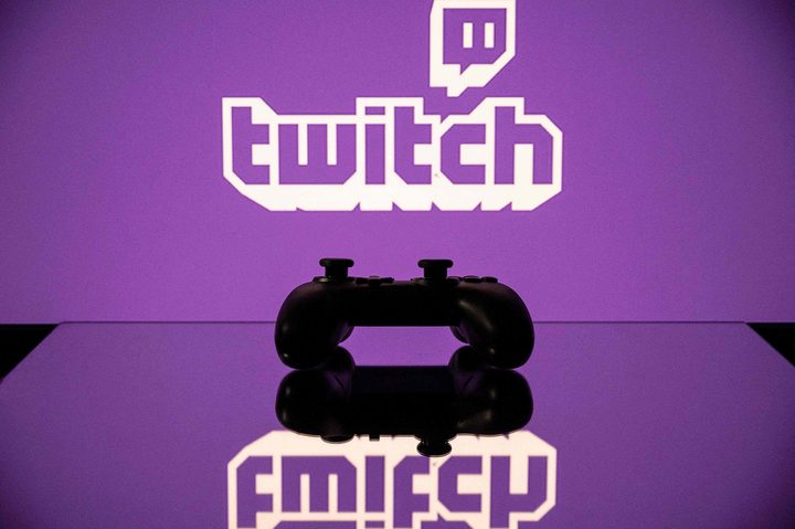 A gamepad is pictured as a screen displays the online Twitch platform.