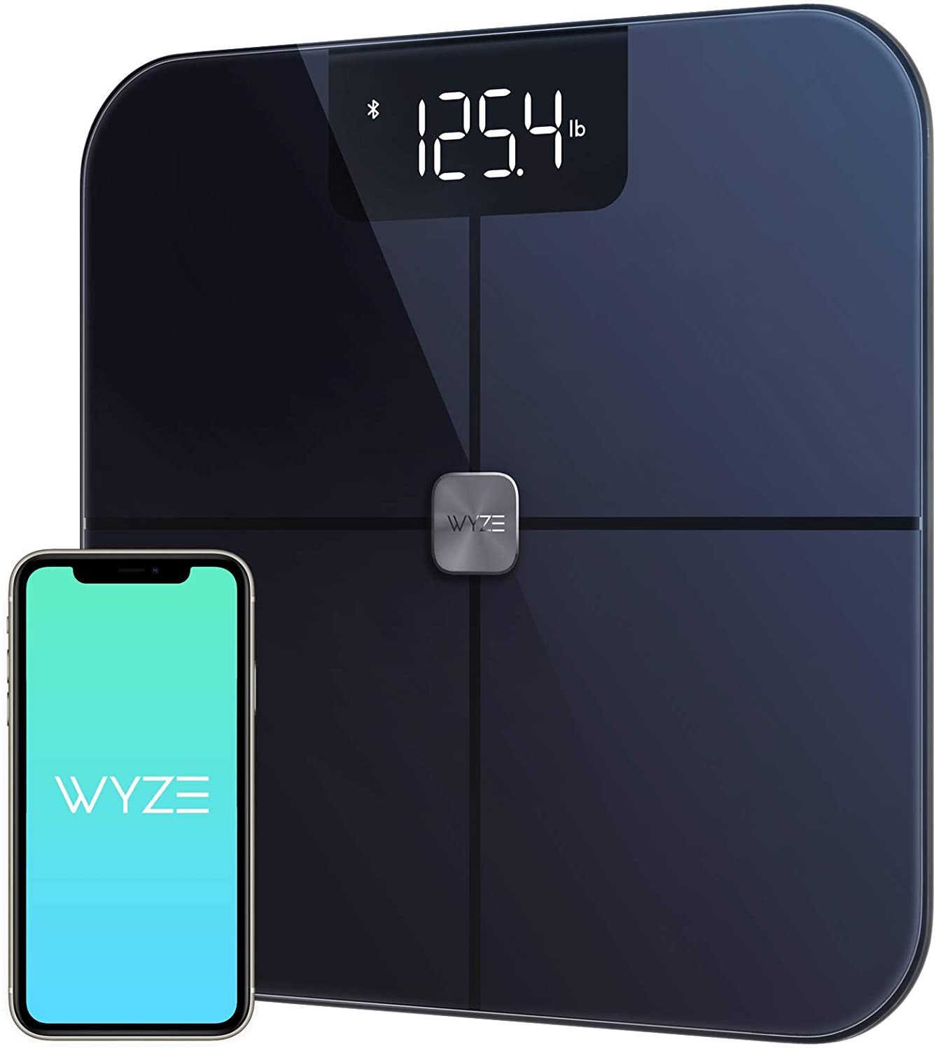 Wyze smart scale in black shown with phone displaying app home screen.