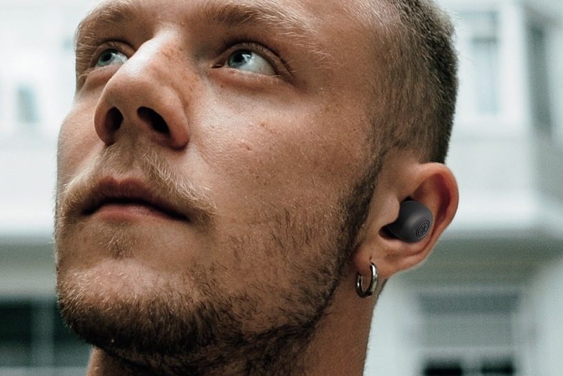 Man wearing Yamaha's TW-E3B true wireless earbuds.