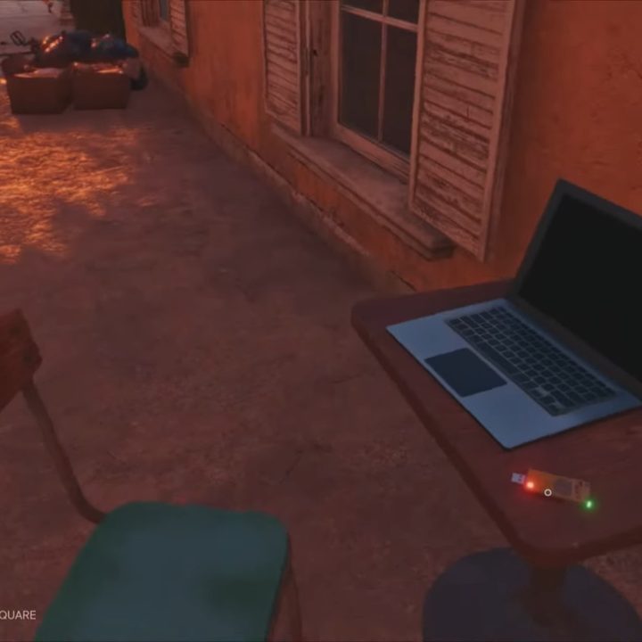 A laptop with a USB next to it.