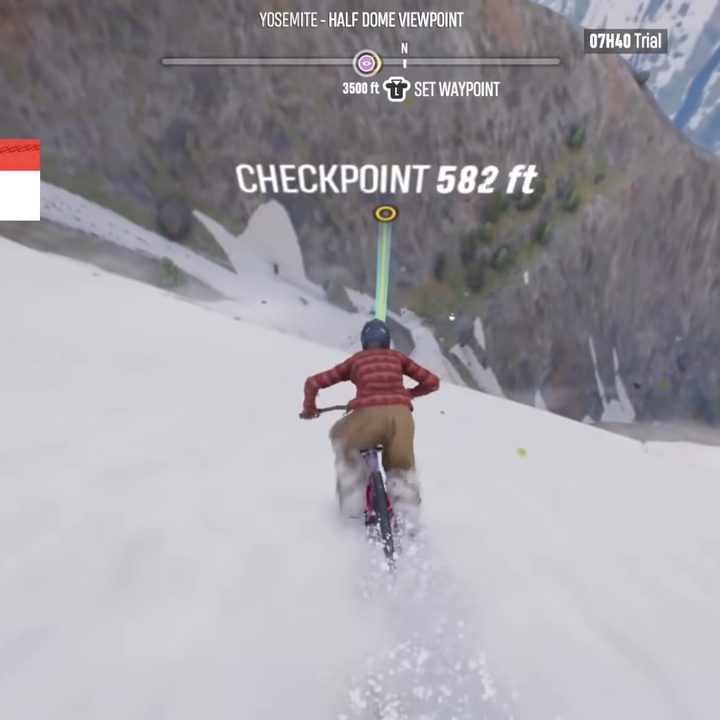 Riding a bike through the snow to a checkpoint.