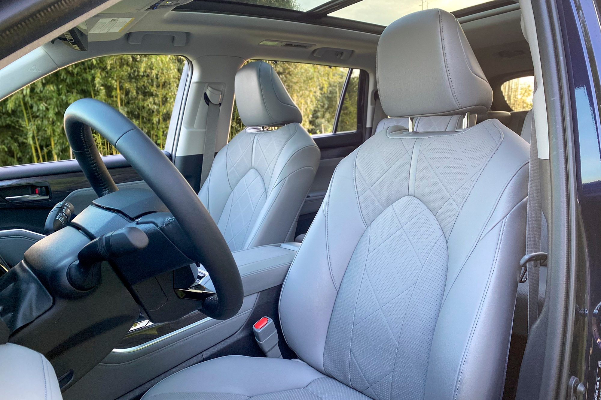 Driver's side interior in the 2021 Toyota Highlander Hybrid Platinum.
