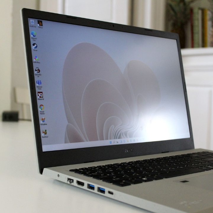 The front of the Acer Aspire Vero against a white cabinet.
