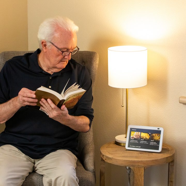 An older man using Alexa.