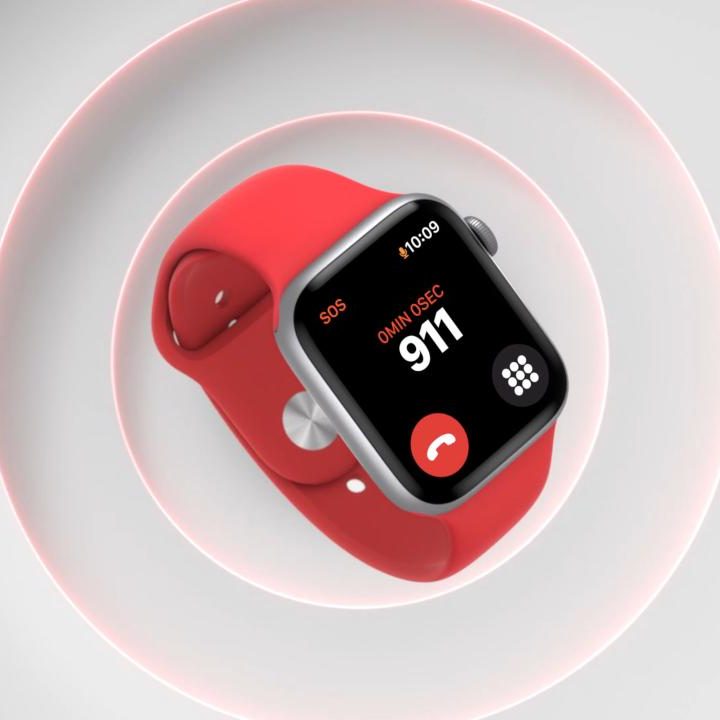 Apple Watch Series 6 smartwatch in red on a white textured background.