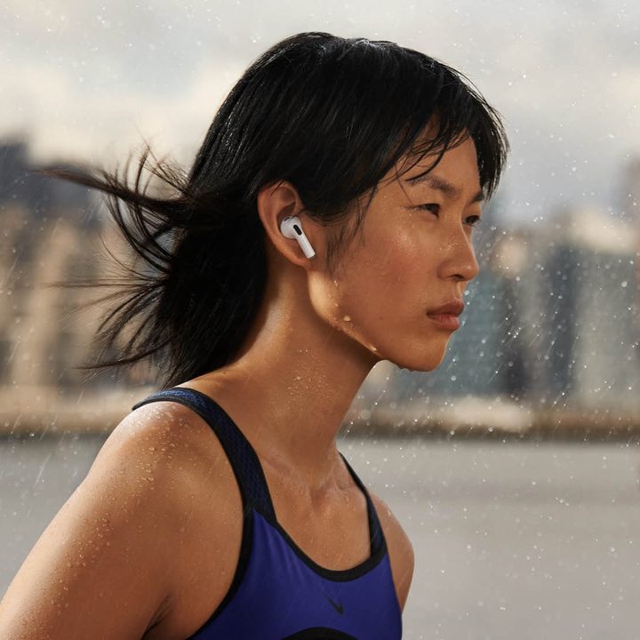 Woman running while wearing the new Airpods 3rd Gen.