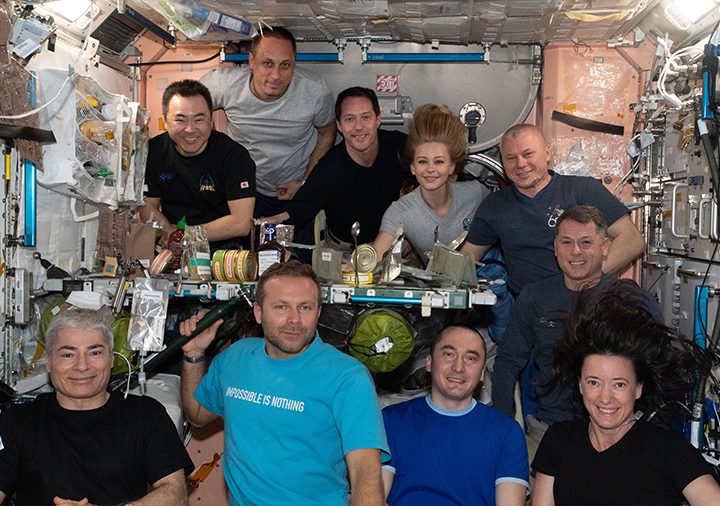 10 ISS inhabitants are gathered together in the Unity module for a meal and a portrait.
