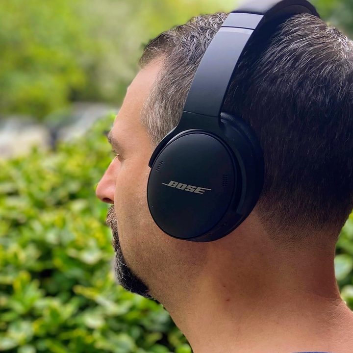 Man wearing Bose QuietComfort 45 noise-canceling headphones.