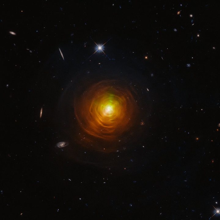A striking observation of the carbon star CW Leonis, which resembles a baleful orange eye glaring from behind a shroud of smoke.