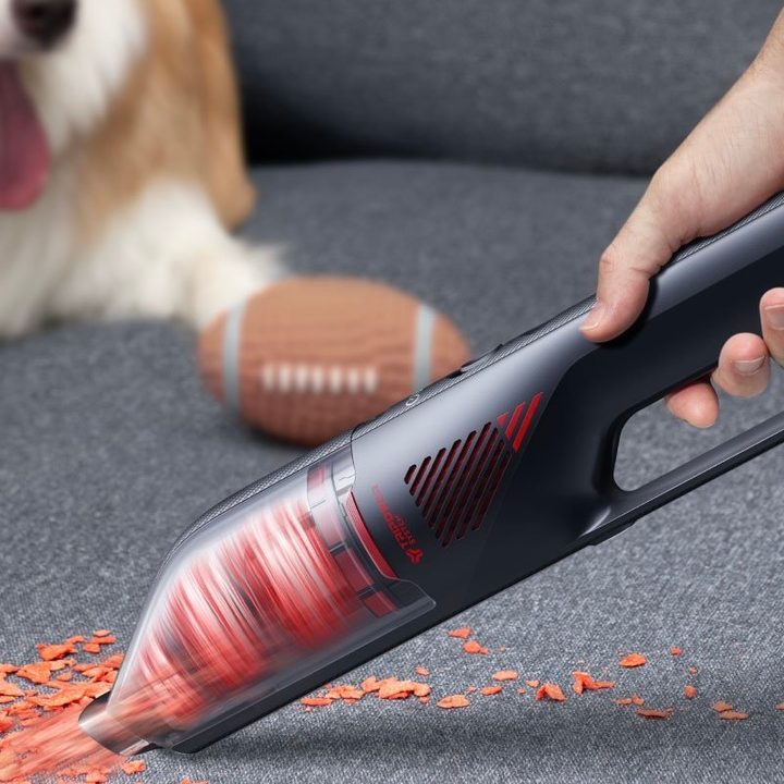 The Eufy HomeVac H30 being used to clean a couch.