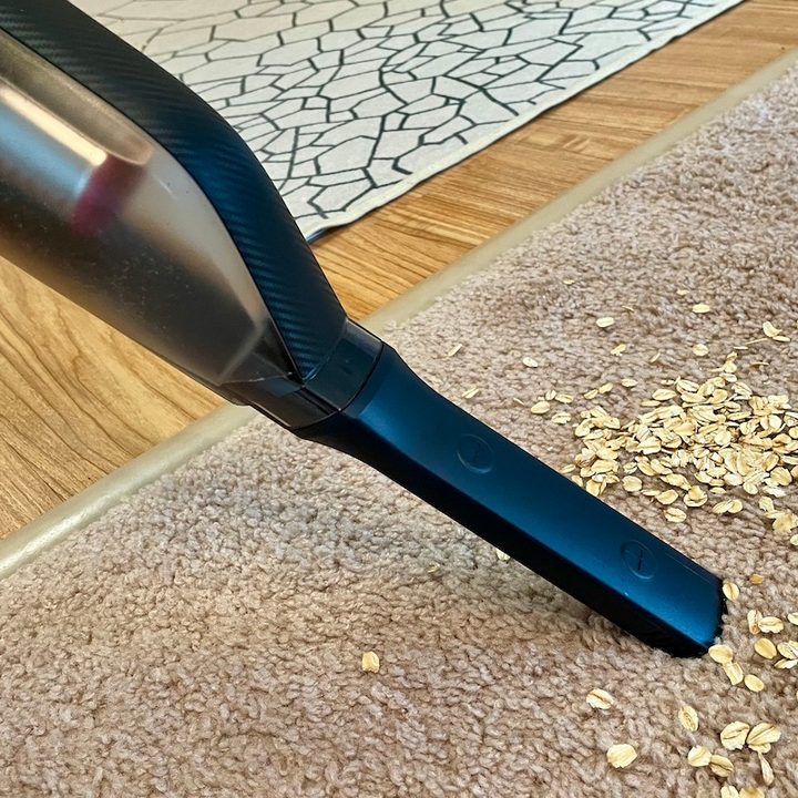 The Eufy HomeVac H30 vacuuming oats from carpeting.