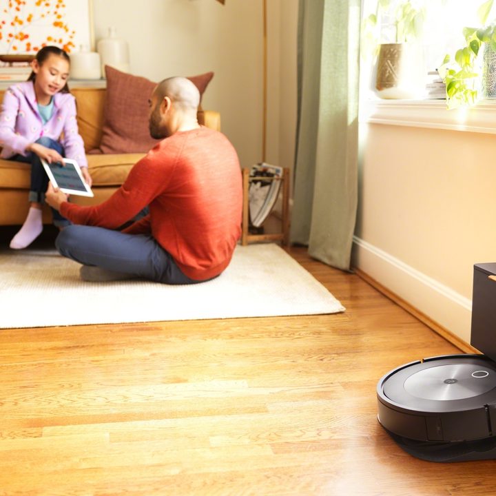 A Roomba vacuum in a living room station.