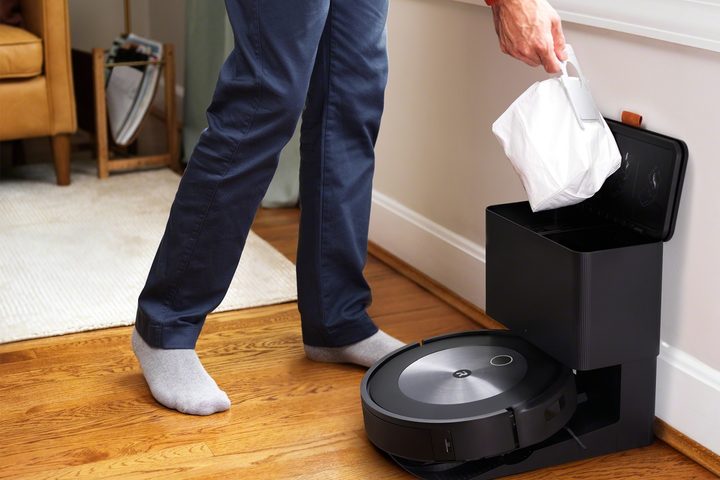 Emptying Roomba waste bin.