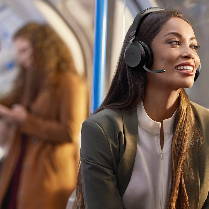 Jabra Evolve2 75 headset woman wearing and using for hybrid work.
