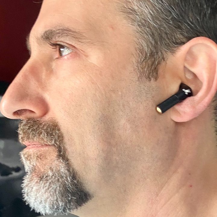 Man wearing Marshall Minor III true wireless earbuds.