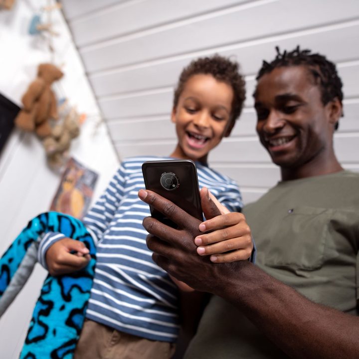 Image of family holding the Nokia G300.