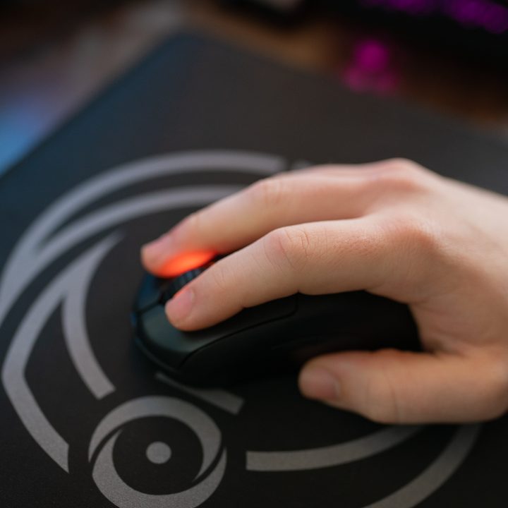 A hand on the Steelseries Prime Wireless mouse.