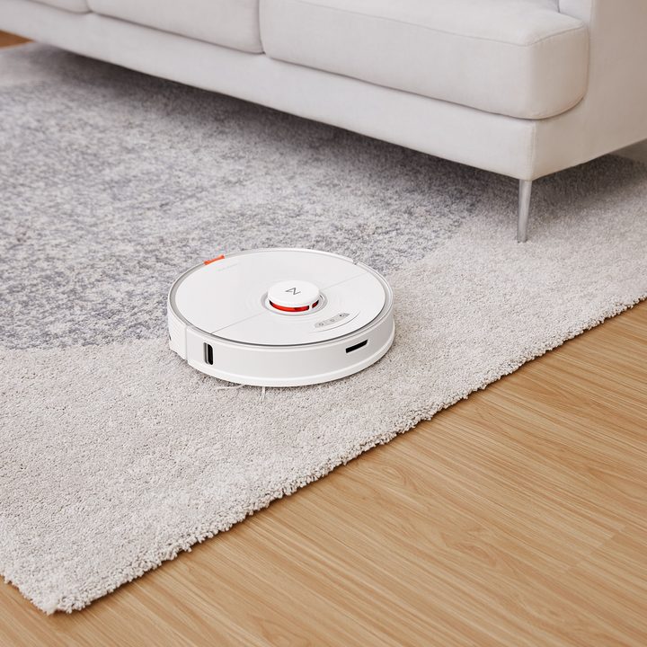 Roborock S7 vacuuming a carpet after raising the mop system.
