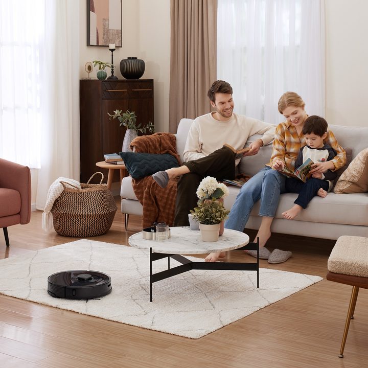 Family in living room with Roborock S7 cleaning.