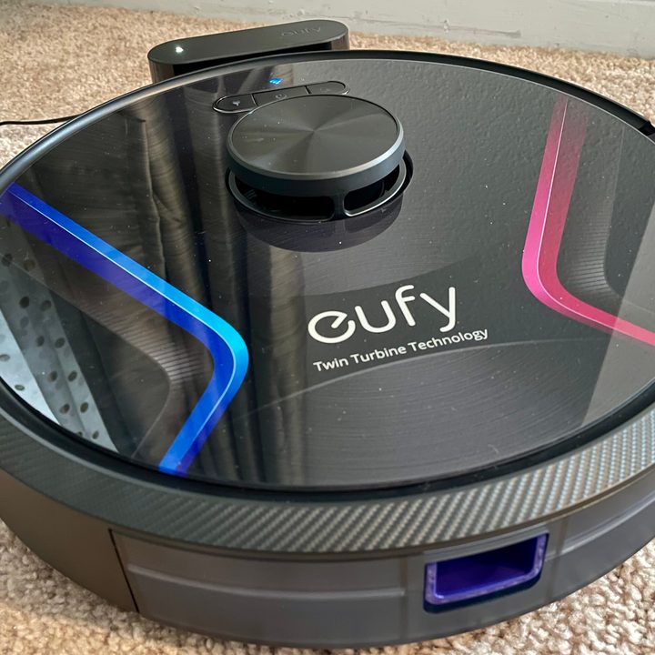 The RoboVac X8 docked on its charger.