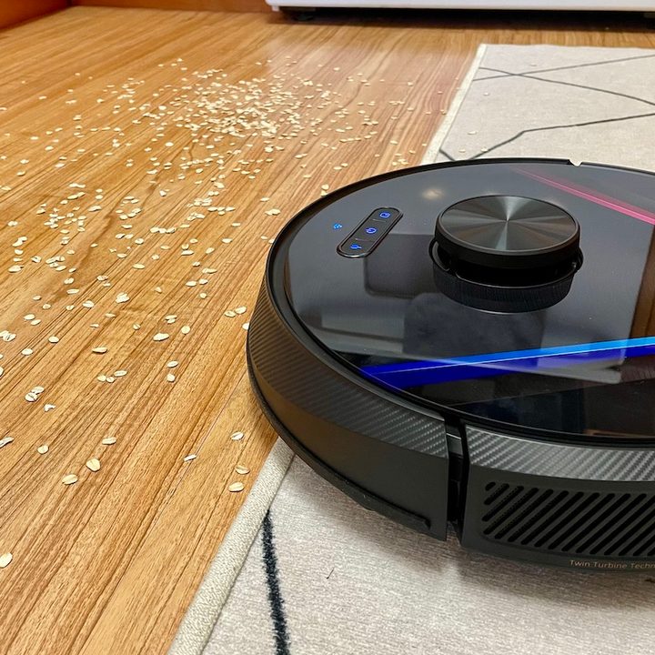 The RoboVac X8 cleaning scattered oats.