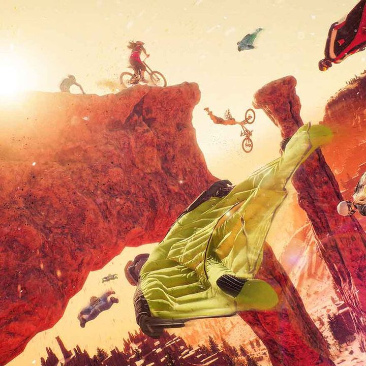 A neon wingsuit flies frough a canyon in Riders Republic.