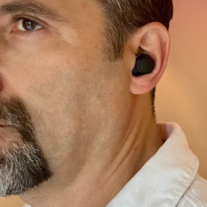 Man wearing Sony WF-C500 true wireless earbuds.