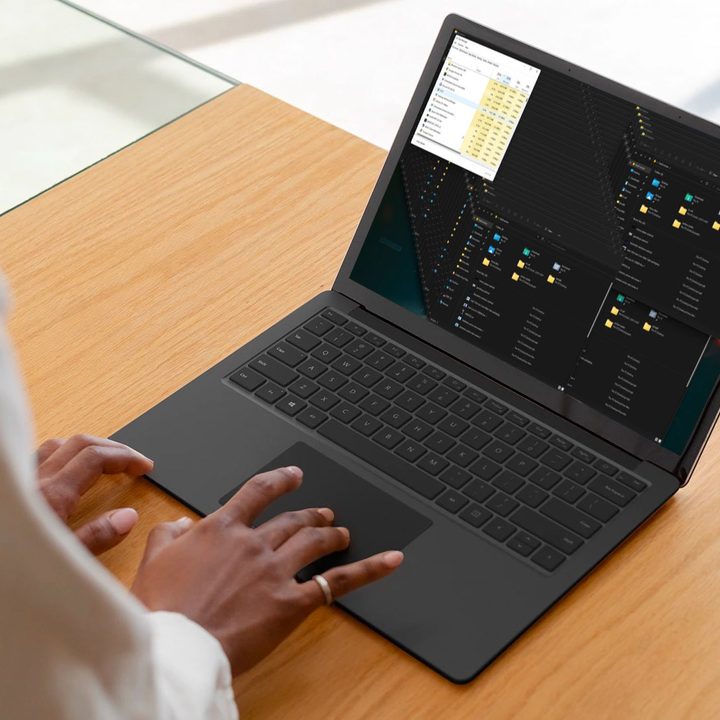 A person using a laptop that is running Windows 11.