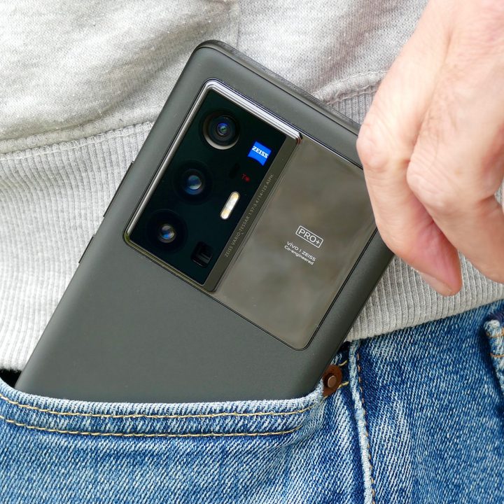 The Vivo X70 Pro+ being taken out of a pocket.