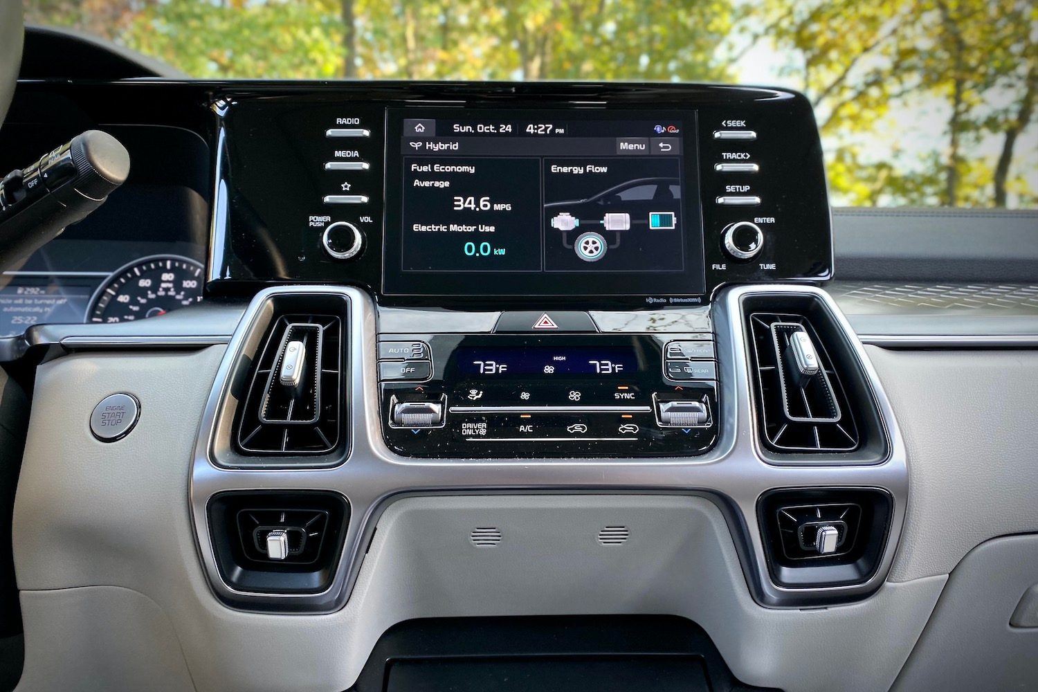 Close of up 2021 Kia Sorento Hybrid center console with trees in the background.