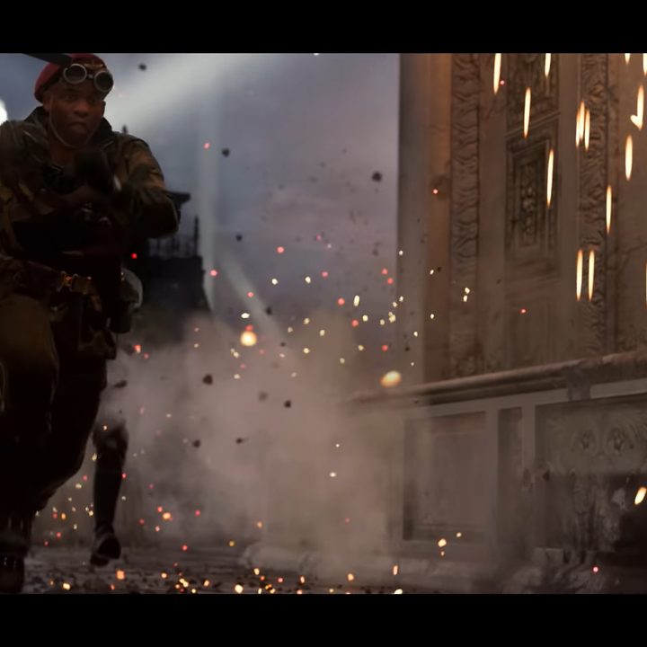 Soldiers running as sparks fall around them.