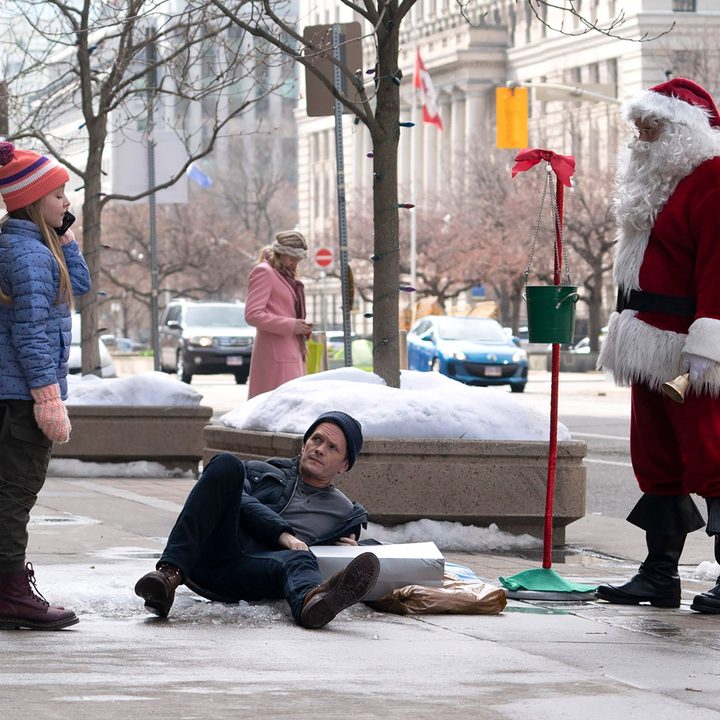 Neil Patrick Harris falls on ice near a Santa Claus in a scene from 8-Bit Christmas.
