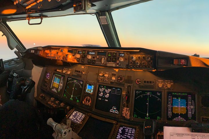 Airliner cockpit with digital instrument panels.