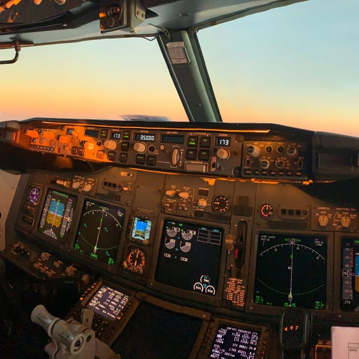 An airliner cockpit with digital instrument panels.