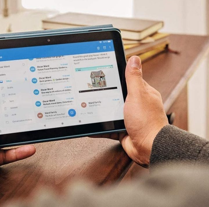 A person holding the Fire HD 8 tablet.