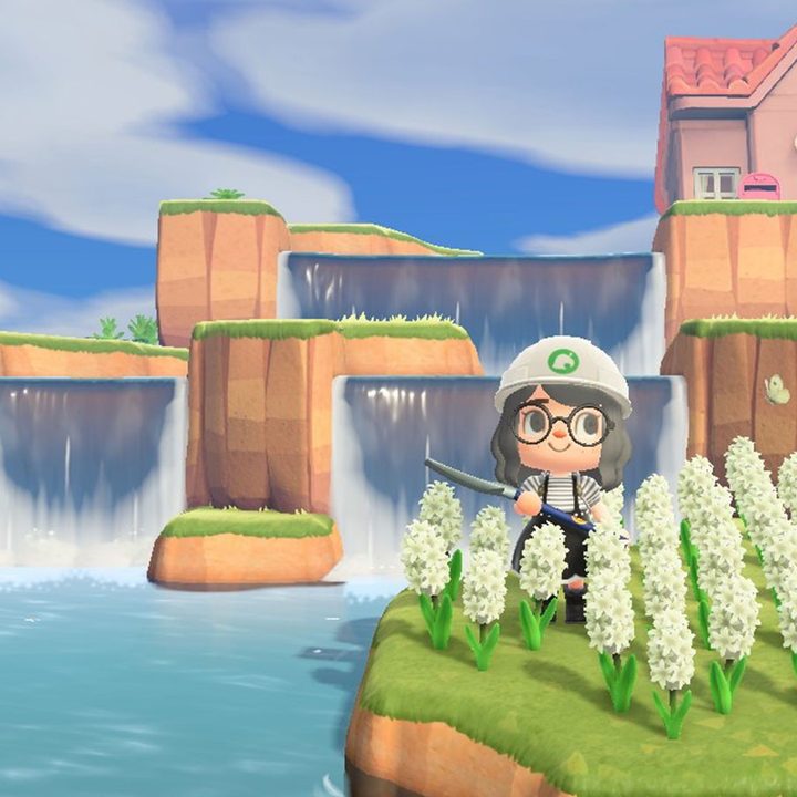 Animal Crossing player poses with their terraformed waterfall.