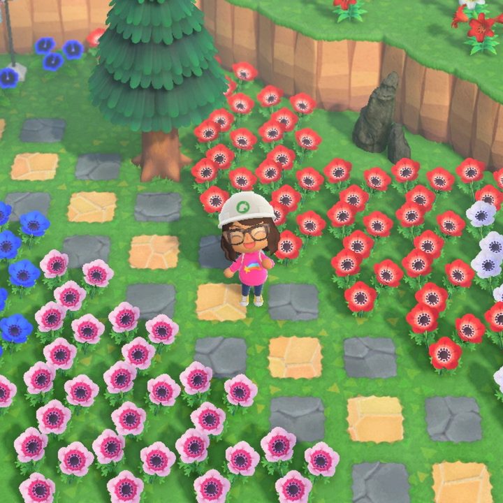 Animal Crossing player standing in their flower garden.