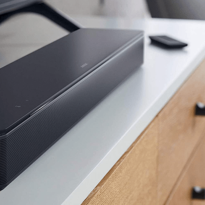 Bose Bluetooth soundbar next to a TV.