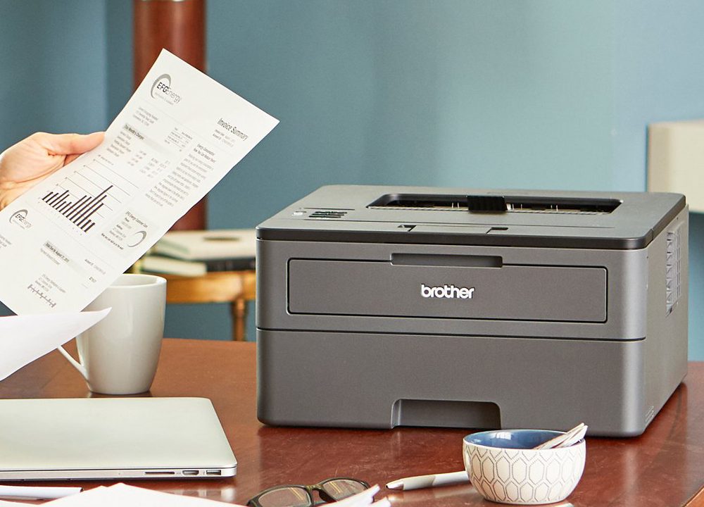Brother HL-L2325DW Monochrome Laser Printer on a desk.