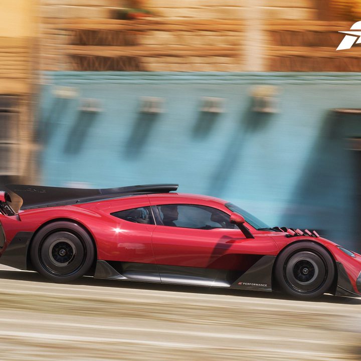 A red car drives fast in Forza Horizon 5.