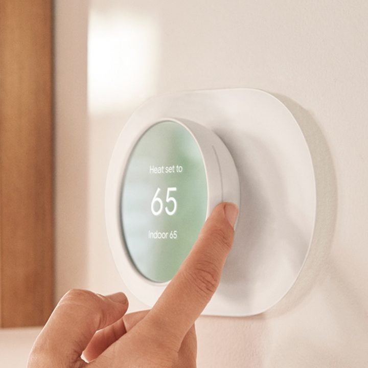 Adjusting the temperature on the Google Nest Thermostat.