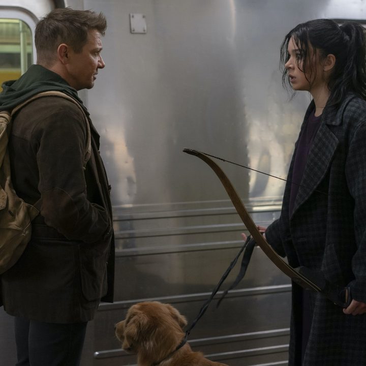 Jeremy Renner, Hailee Steinfeld, and Luckythe Pizza Dog wait for a train in a scene from Hawkeye.