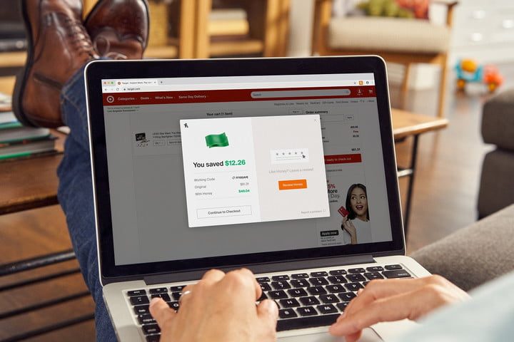 A person's hands using a laptop to online shop with the Honey browser extension.