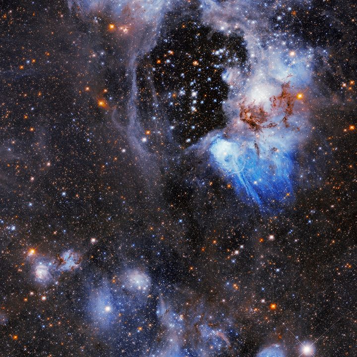 A dark, starry gap called a “superbubble,” visible in this Hubble Space Telescope image of Nebular N44 in the upper central region.