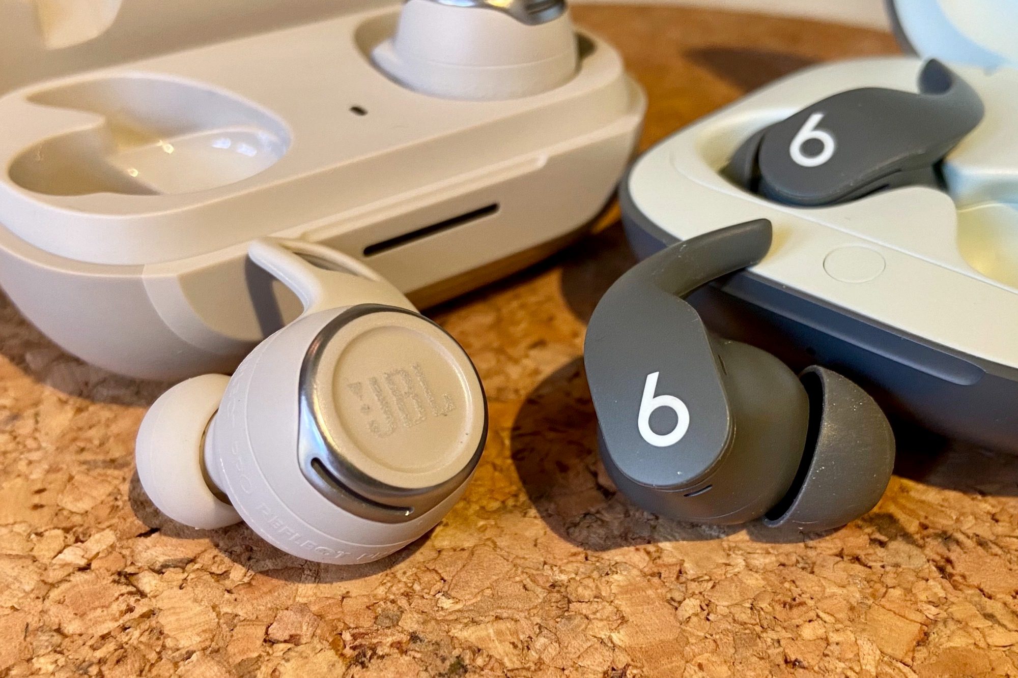 JBL Reflect Flow Pro charging case seen next to Beats Fit Pro.