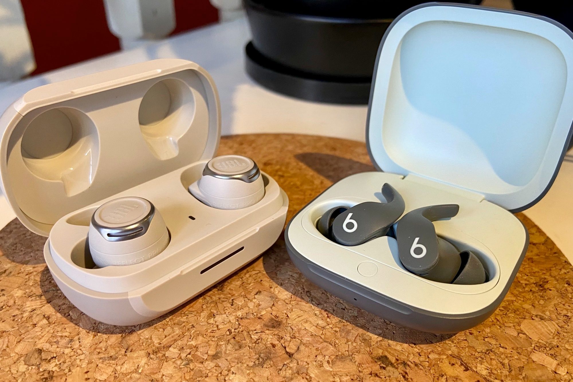JBL Reflect Flow Pro charging case seen next to Beats Fit Pro.