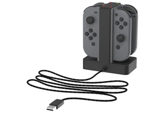 Four Joy-Cons plugged into a charging deck.