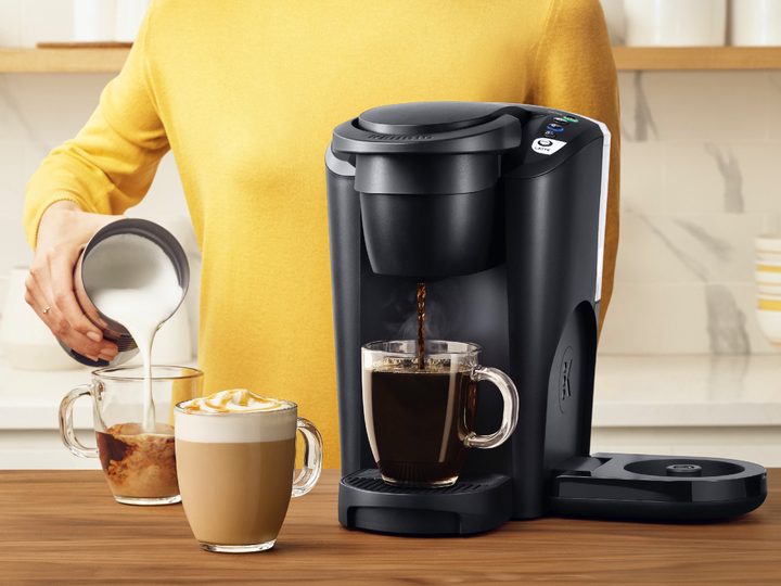 Close-up of a person pouring a latte made by the Keurig K-Latte coffee maker.
