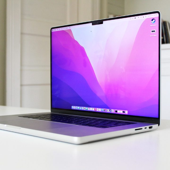 The 2021 MacBook Pro with the lid open on a white table.