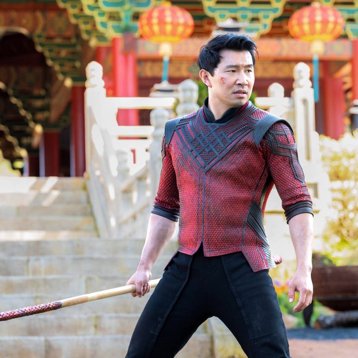 Marvel Studios' Shang-Chi and The Legend of The Ten Rings with Shang-Chi holding a fighting stick.